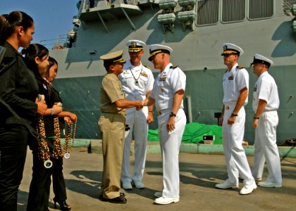 US Navy 110628-N-NJ145-282 Cmdr. Scott Erb, commanding officer of the guided-missile destroyer USS Chung-Hoon (DDG-93) is met at the pier