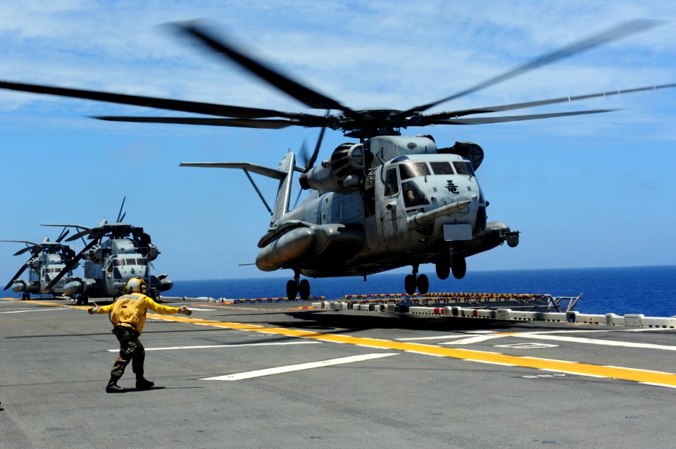 US Navy 110629-N-WA347-039 Aviation Boatswain's Mate (Handling) Airman Chamika Mcintush directs a CH-53E Sea Stallion helicopter aboard the forward