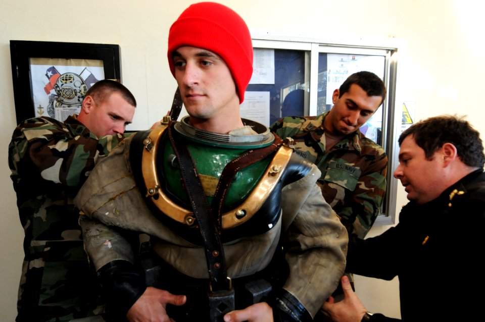 US Navy 110630-N-XD935-211 Navy Diver 2nd Class Ryan Arnold dresses in a full Mark V diving suit during a tour of the Chilean navy dive school