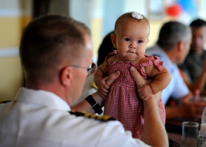 US Navy 110630-N-NY820-207 Capt. David Weiss holds a child at a luncheon following a welcoming ceremony as part of Continuing Promise 2011