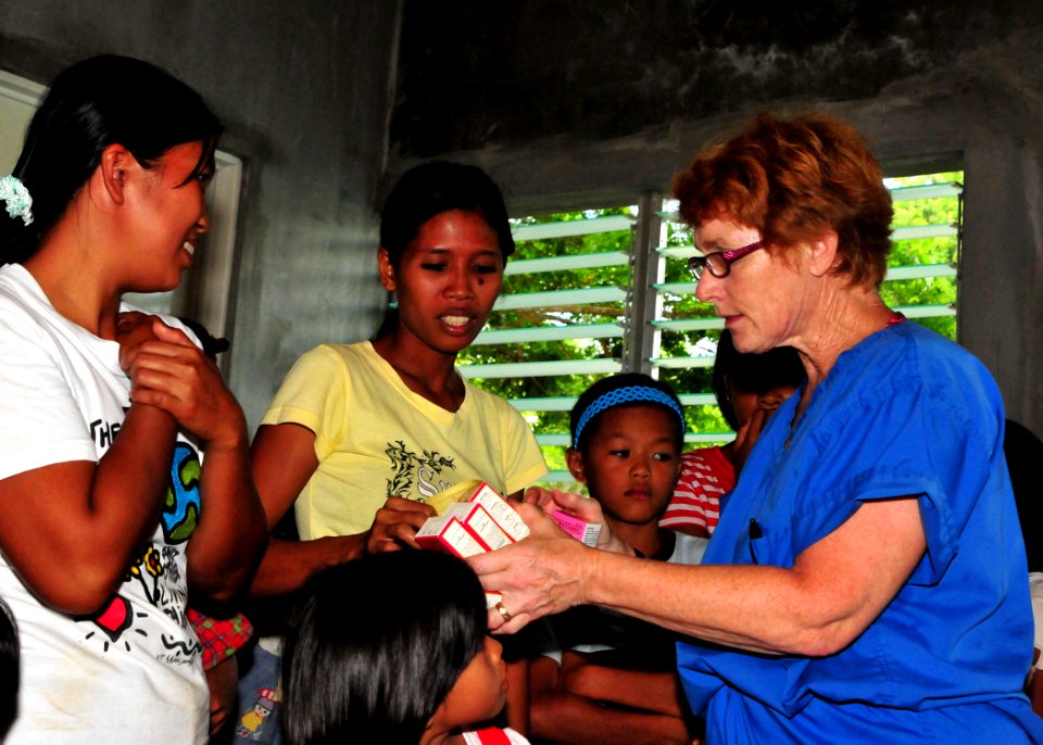 US Navy 110629-N-NJ145-045 Master Chief Hospital Corpsman Denise Becker explains a prescription dosage to a patient during a medical community serv