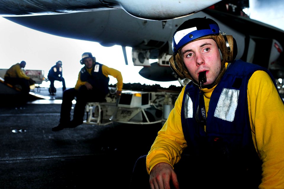 US Navy 110627-N-SB672-017 Aviation Boatswain's Mate Airman Justin Martin, from Memphis, Tenn., moves an aircraft with a spotting dolly in the han
