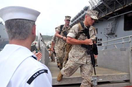 US Navy 110627-N-ZZ999-007 Marines assigned to the 31st Marine Expeditionary Unit (31st MEU) board the forward deployed amphibious assault ship USS photo