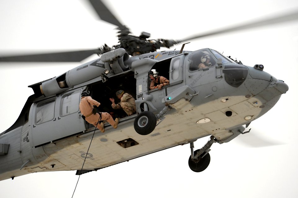 US Navy 110630-N-WL435-710 A Navy explosive ordnance disposal technician assigned to Task Group (TG) 56.1 jumps from a helicopter