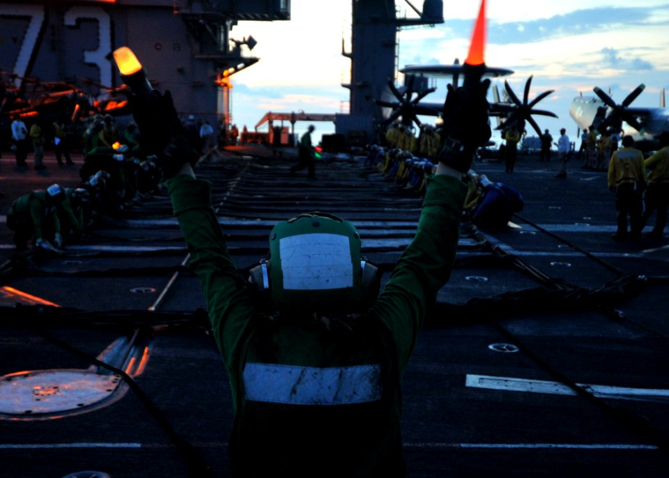 US Navy 110702-N-ZY721-008 Sailors pull on barricade lines during a night time barricade drill aboard USS George Washington (CVN 73)