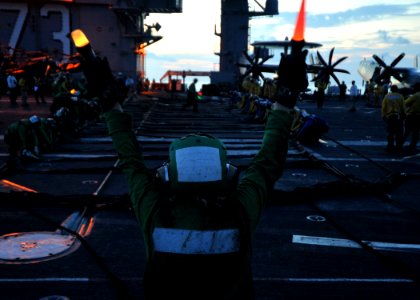 US Navy 110702-N-ZY721-008 Sailors pull on barricade lines during a night time barricade drill aboard USS George Washington (CVN 73) photo