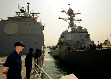 US Navy 110701-N-YM590-017 Sailors man the rails as the guided-missile cruiser USS Anzio (CG 68) departs Djibouti photo