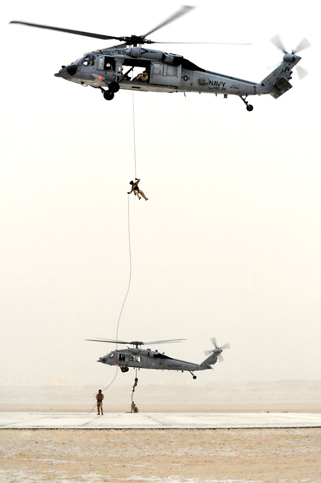 US Navy 110630-N-WL435-103 Navy explosive ordnance disposal technicians assigned to Task Group (TG) 56.1 perform a tactical personnel insertion
