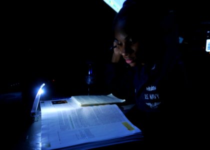 US Navy 110702-N-EE987-049 Fire Controlman 2nd Class Lisa Smith, from Hartford, Ct., studies for a psychology test aboard the aircraft carrier USS photo