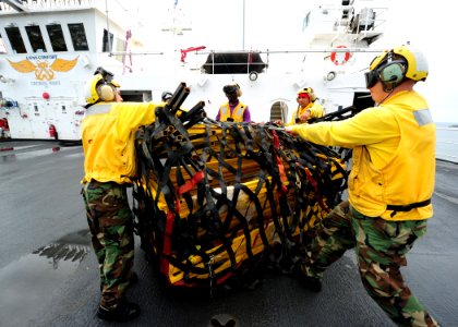 US Navy 110630-N-QD416-048 Sailors aboard the Military Sealift Command hospital ship USNS Comfort (T-AH 20) prepare supplies for transfer to a medi