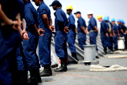 US Navy 110701-N-TY225-010 Sailors assigned to the guided-missile cruiser USS Anzio (CG 68) man the rails as the ship gets underway photo