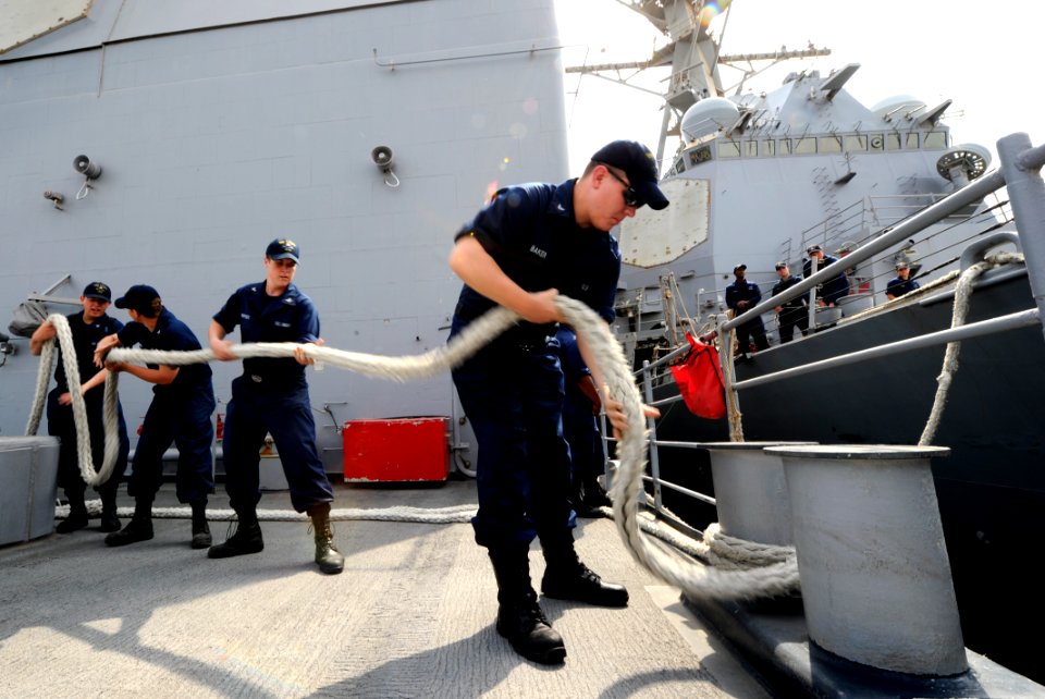 US Navy 110701-N-TY225-032 Sailors assigned to the guided-missile cruiser USS Anzio (CG 68) heave in the lines as the ship gets underway