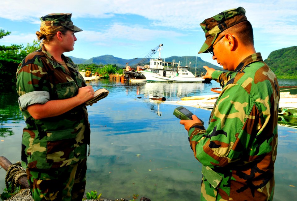 US Navy 110706-N-KB563-150 Lt. Blair Johnson, left, and Boatswain's Mate 1st Class Oscar Pacquing set a global positioning system fix on a pier dur
