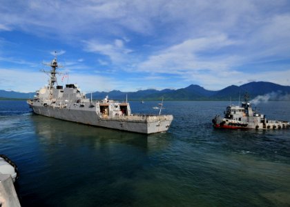 US Navy 110704-N-XR557-047 The guided-missile destroyer USS Howard (DDG 83) is trailed by a tug boat as the ship leaves port for the underway phase