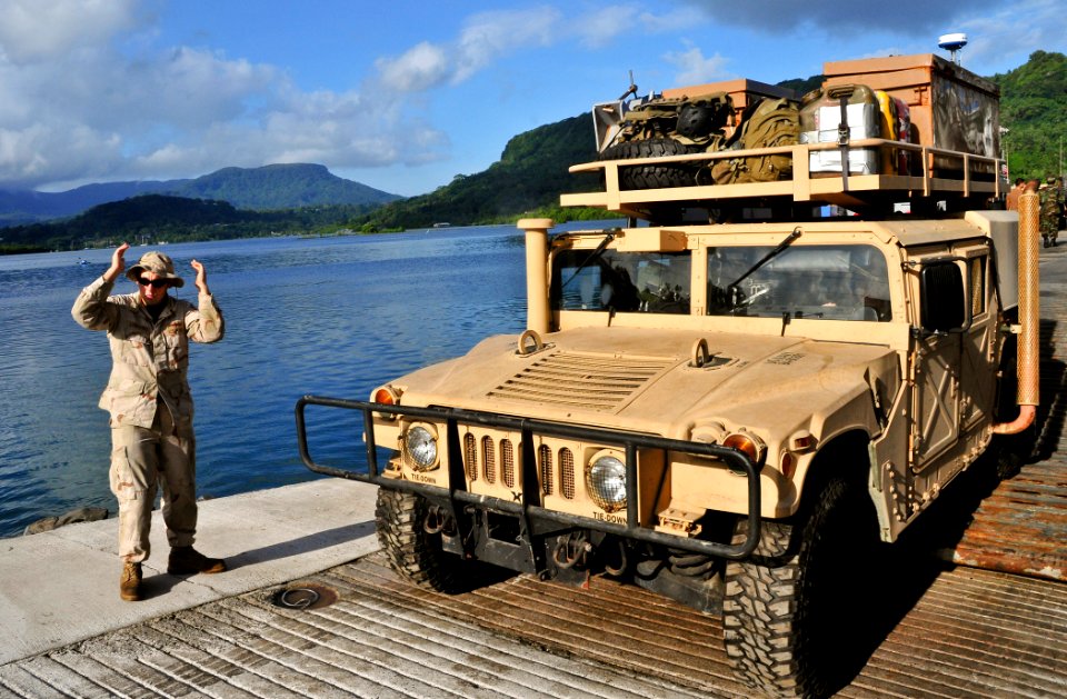 US Navy 110703-O-ZZ999-006 Yeoman Seamen Tony Lomauro directs a HUMVEE from Landing Craft Utility (LCU) 1665