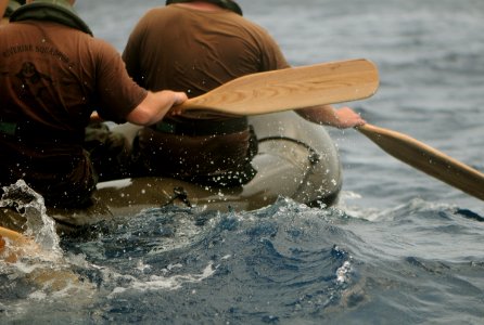 US Navy 110705-N-YO394-318 Sailors and Royal Netherlands marines paddle an inflatable boat during a six-kilometer amphibious march along the island