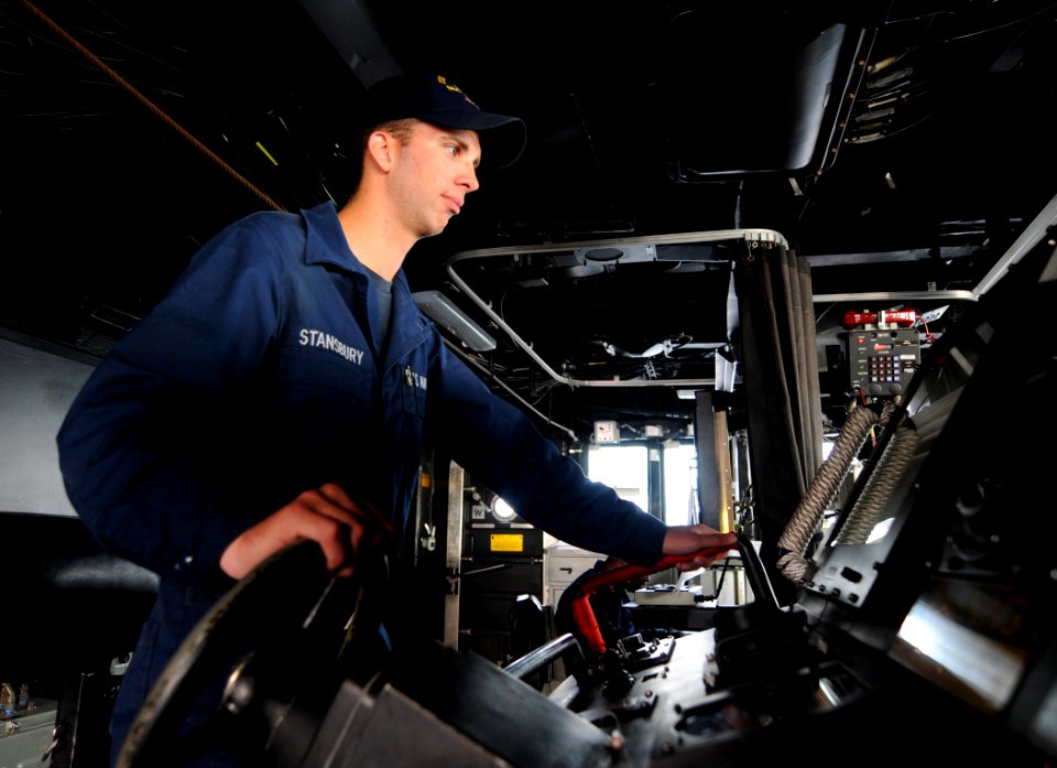 US Navy 110705-N-TB177-037 Boatswain's Mate Seaman Richard Stansbury steers the ship from the bridge aboard the guided-missile destroyer USS Truxtu