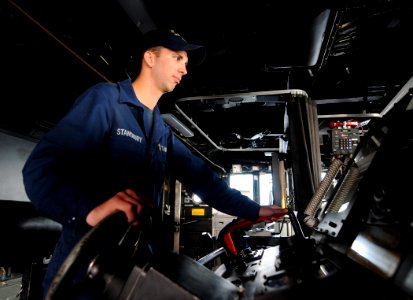 US Navy 110705-N-TB177-037 Boatswain's Mate Seaman Richard Stansbury steers the ship from the bridge aboard the guided-missile destroyer USS Truxtu photo