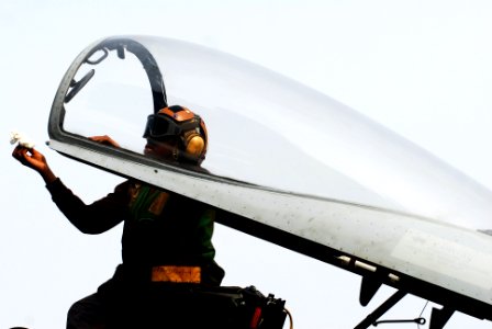 US Navy 110702-N-GL340-006 Aviation Machinist's Mate Airman Wilda Saint-Louis, from Miami, cleans the fuselage of an aircraft on the flight deck of