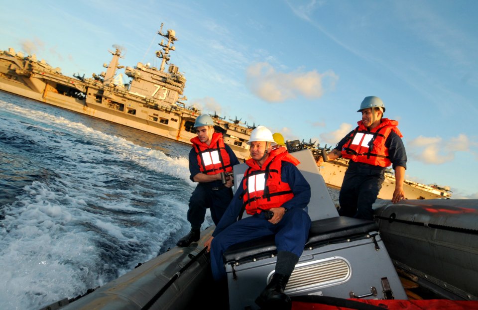 US Navy 110703-N-SF704-022 Sailors assigned to USS George Washington (CVN 73) make a hard turn in a rigid-hull inflatable boat (RHIB) during a RHIB