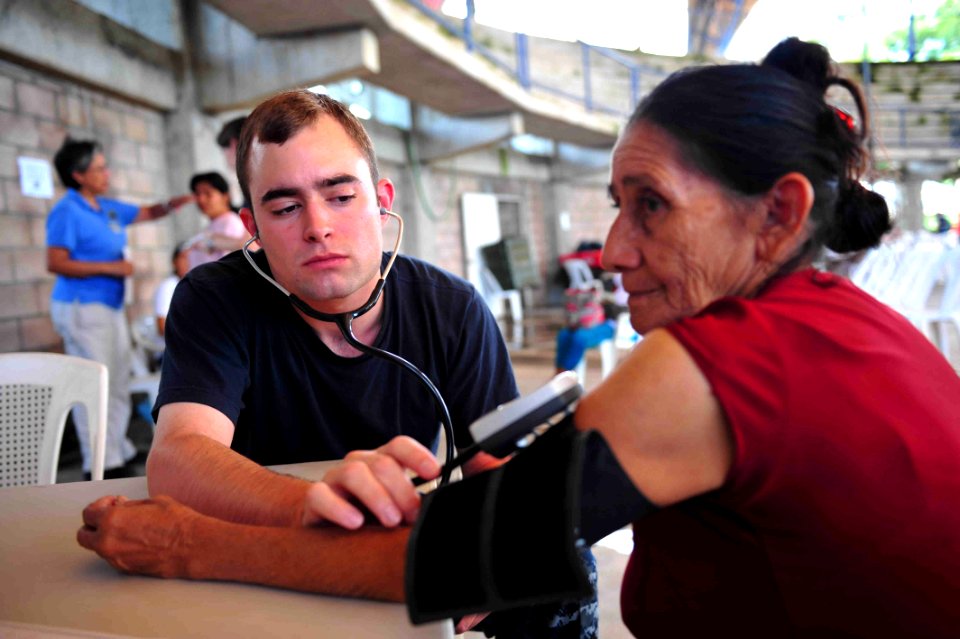 US Navy 110715-F-NJ219-070 Midshipman Matthew Milam, from Memphis, Tenn., checks a patient's blood pressure