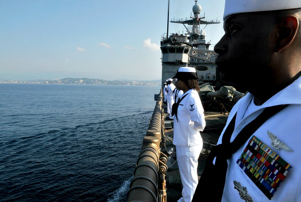 US Navy 110703-N-AG285-032 Personnel Specialist 1st Class Darryl Thomas mans the rails aboard USS Whidbey Island (LSD 41), as the ship anchors off
