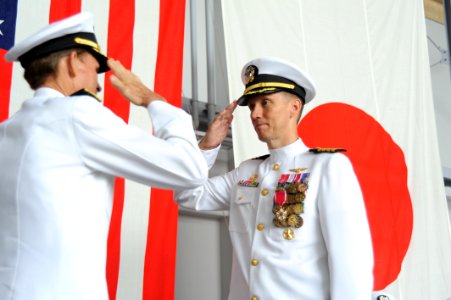 US Navy 110708-N-KK192-489 Rear Adm. Dan Cloyd, left, commander of Naval Forces Japan, salutes Capt. James Haugen