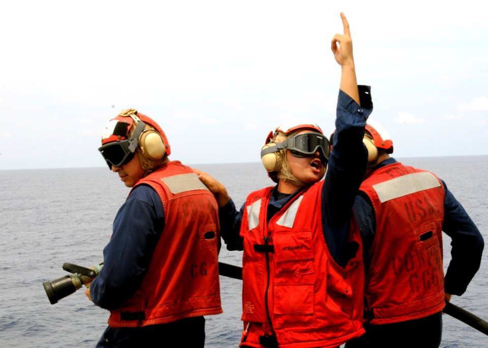 US Navy 110701-N-KB052-411 Culinary Specialist 3rd Class Aaron Quiambao communicates with the damage control on-scene leader during a crash and sal
