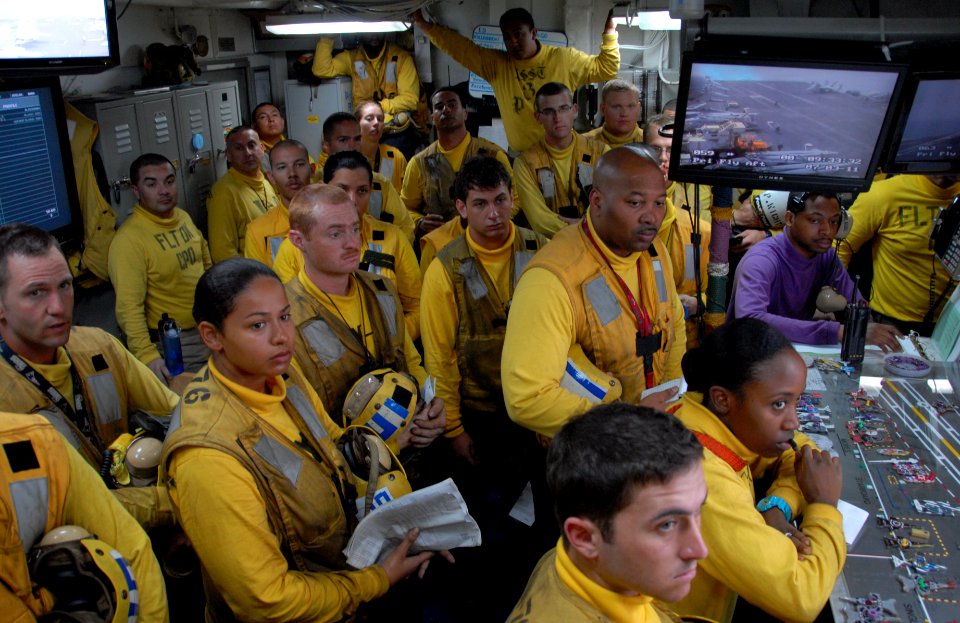 US Navy 110703-N-KF029-371 Aviation boatswain's mates (Handling) conduct a yellow-shirt briefing in flight deck control aboard the aircraft carrier