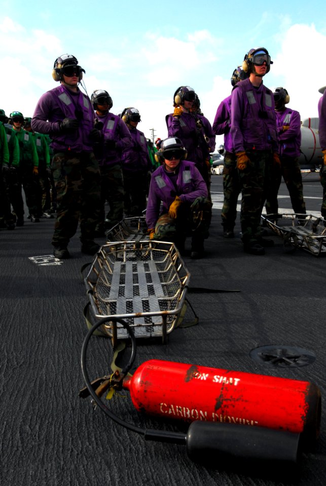 US Navy 110705-N-AW206-005 tretcher bearers stand by for instruction during a mass casualty drill aboard USS George Washington (CVN 73)