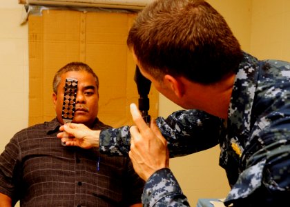 US Navy 110707-N-BC134-039 Cmdr. Richard Zeber performs an eye exam at the Kosrae hospital during Pacific Partnership 2011 photo