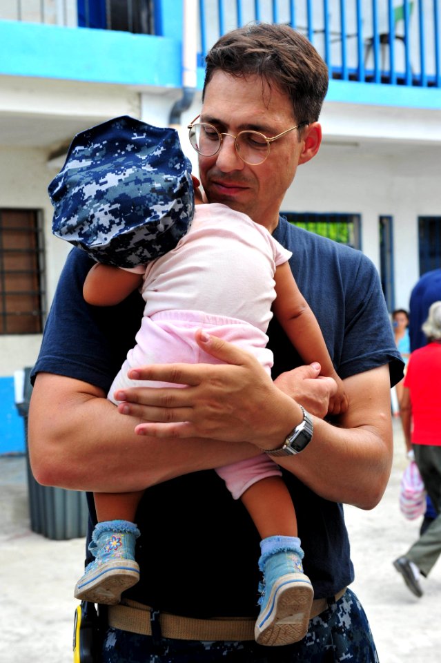 US Navy 110706-F-NJ219-171 Lt. Cmdr. Jason Layton, a nurse from Wexford, Penn., holds a baby during a Continuing Promise 2011 medical community ser
