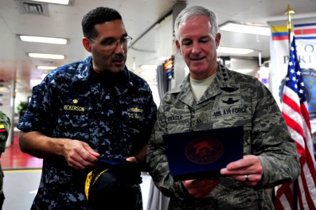 US Navy 110707-F-NJ219-217 Commodore Brian Nickerson, mission commander of Continuing Promise 2011, presents Air Force Gen. Douglas Fraser, command photo