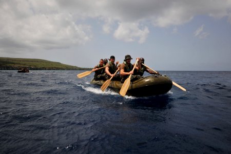 US Navy 110705-N-YO394-124 Sailors and Royal Netherlands marines paddle an inflatable boat during a six-kilometer amphibious march along the island