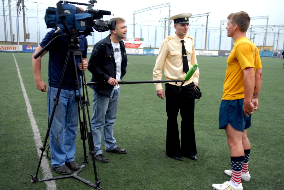US Navy 110703-N-MU720-094 Sonar Technician (Surface) 2nd Class Timothy Brogdon is interviewed by local media during a sporting event