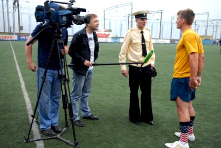 US Navy 110703-N-MU720-094 Sonar Technician (Surface) 2nd Class Timothy Brogdon is interviewed by local media during a sporting event