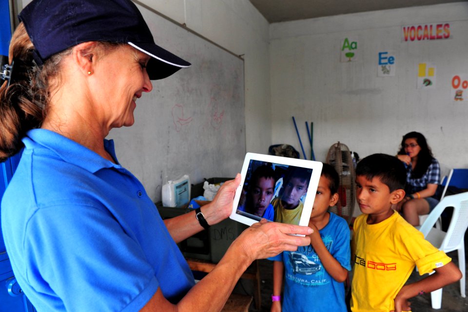 US Navy 110706-F-NJ219-111 Gene Berrett, a Latter-day Saints Charities volunteer from Salt Lake City, takes a photo of Guatemalan children during a