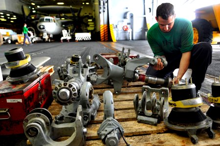 US Navy 110703-N-EE987-001 Aviation Machinist's Mate Airman Casey Brucklacher, from Sacramento, Calif., prepares parts of a rotor for installation