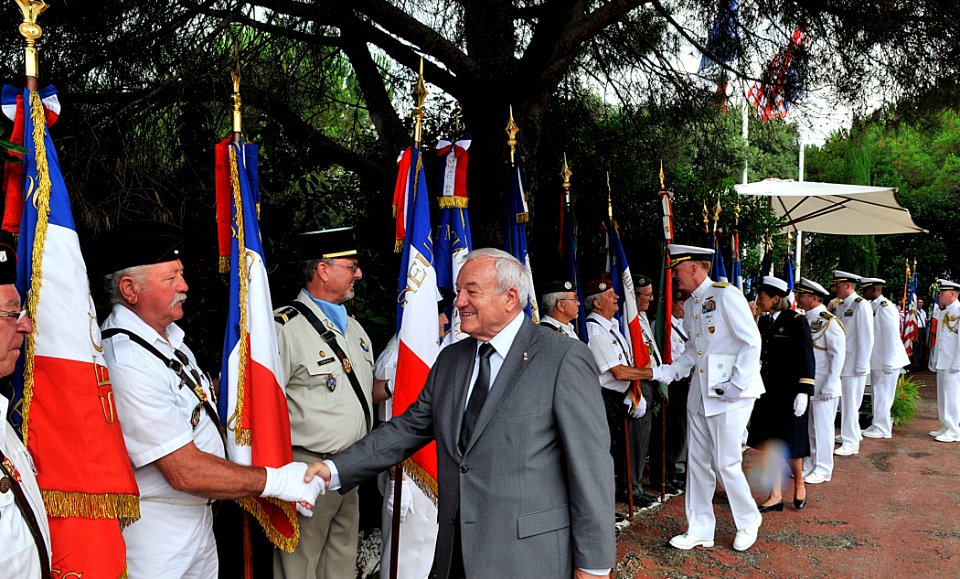 US Navy 110704-N-AG285-236 The mayor of Cannes, France, Bernard Brochand, shakes hands with official flag bearers during a memorial service honorin