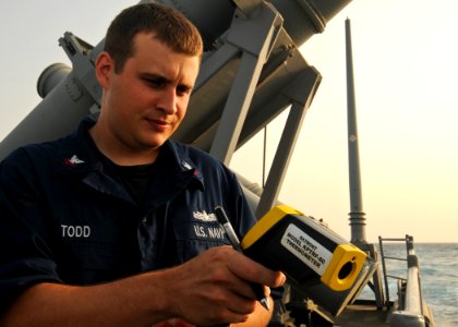 US Navy 110705-N-YM590-020 Fire Controlman 2nd Class Dannon Todd uses a KPTRF-80 infra-red thermometer to test the water temperature as part of an