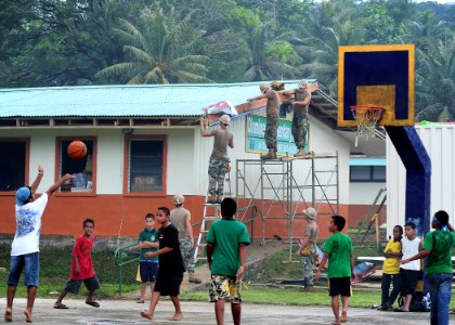US Navy 110708-F-HS649-219 Micronesian boys play basketball next to the Ohmine engineering civic action project during the Federated States of Micr