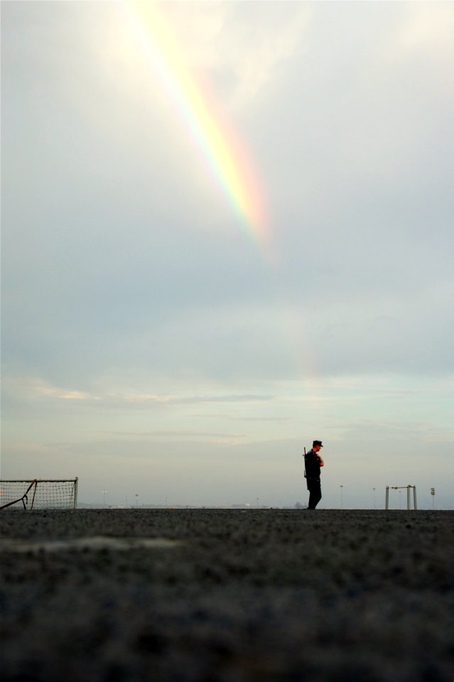 US Navy 110705-N-ZC343-979 A rainbow appears above the flight deck security rover as he makes his rounds aboard the amphibious assault ship USS Bon