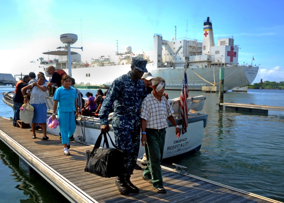 US Navy 110706-N-NY820-014 Hospitalman Augustus Lartey escorts a patient from the Military Sealift Command hospital ship USNS Comfort (T-AH 20)