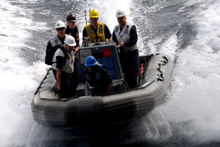 US Navy 110706-N-GL340-052 Sailors aboard a rigid-hull inflatable boat (RHIB) approach the aircraft carrier USS Ronald Reagan (CVN 76)