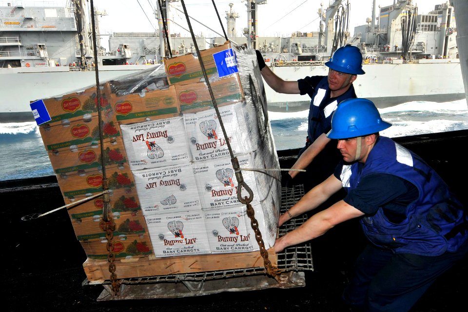 US Navy 110707-N-EE987-109 Boatswain's Mate Seaman Jason Mann, from Langtry, Texas, and Corey Enff, from Norborne, Mo., stabilize a pallet of suppl