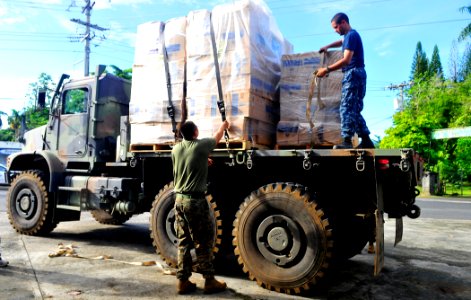 US Navy 110706-N-KB563-204 A Sailor and a Marine participating in Pacific Partnership 2011 strap down boxes of donations that will be given to the