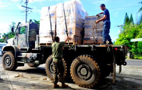 US Navy 110706-N-KB563-204 A Sailor and a Marine participating in Pacific Partnership 2011 strap down boxes of donations that will be given to the photo