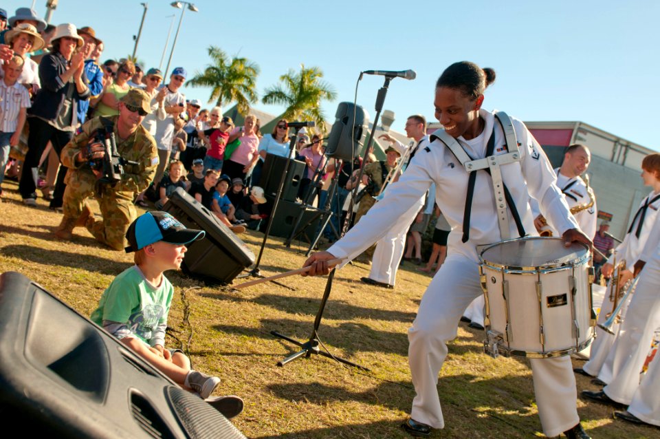 US Navy 110709-N-CZ945-703 Musician 3rd Class Camellia Akhami interacts with a boy during the opening ceremony performance for Talisman Sabre 2011