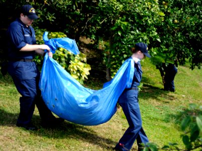 US Navy 110705-N-XG305-407 Sailors carry leaves during a community service project at the Little Sisters of the Poor retirement home