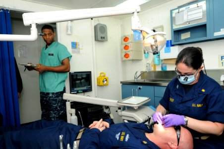 US Navy 110709-N-NB544-019 Lt. Brittany Tucker, from Aztec, N.M., conducts a dental exam aboard the aircraft carrier USS Ronald Reagan (CVN 76) photo